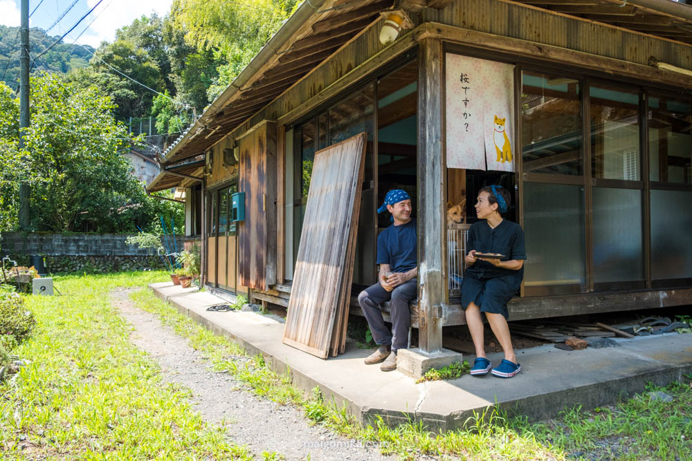 man and woman sitting on edge of engawa in a traditional japanese home, once an akiya